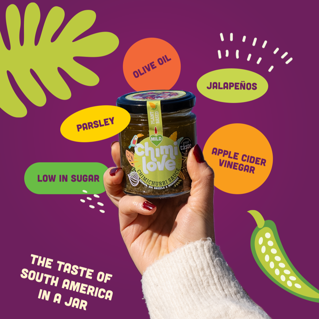 A hand holding a jar of Chimi Love Mild Chimichurri Sauce